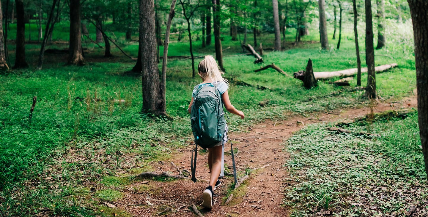 Girl hiking through the woods